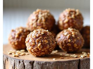 A close-up of homemade energy balls and healthy snack bars arranged attractively, perfect for a quick energy boost.