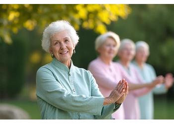 A serene outdoor scene of seniors performing slow, graceful Tai Chi movements in a park.